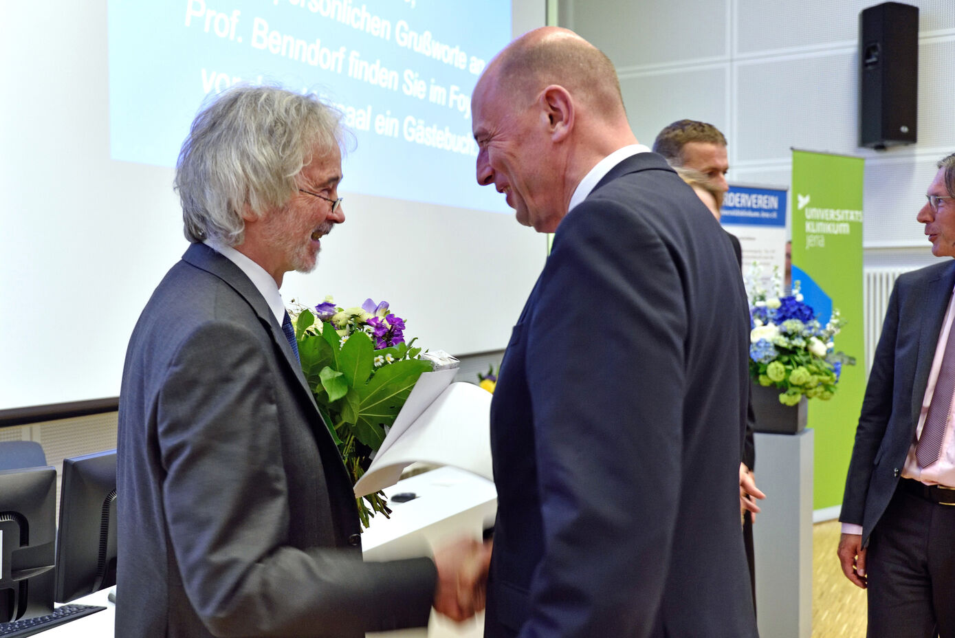 Wissenschaftsminister Wolfgang Tiefensee (rechts) gratuliert dem ehemaligen Dekan und Wissenschaftlichen Vorstand Klaus Benndorf zu seinem Wirken in elf Jahren Amtszeit. Foto: UKJ/Szabó.  