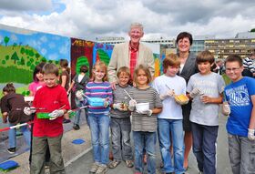 Dr. Karen Treuter (UKJ) und Ortsbürgermeister Volker Blumentritt (hier mit einer Gruppe der Lobdeburgschule) sind vom Engagement der Schülerinnen und Schüler begeistert. Eine Woche lang gestalteten die Kinder und Jugendlichen unter fachkundiger Betreuung große Teile des rund 500 Meter langen Bauzauns